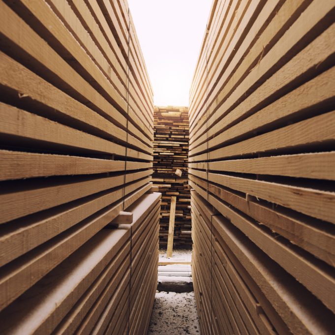 Stack of wooden planks in sawmill lumber yard.